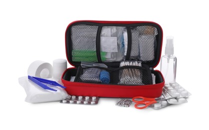 Photo of First aid kit, scissors, pins, cotton buds, pills, plastic forceps, hand sanitizer, medical plaster and elastic bandage isolated on white