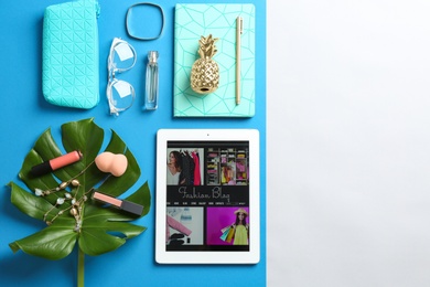 Photo of Flat lay composition with tablet, makeup products and accessories on color background, space for text. Fashion blogger