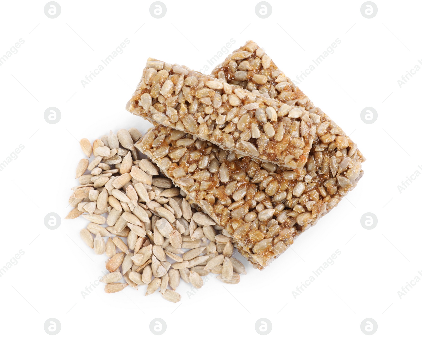 Photo of Delicious sweet kozinaki bars and sunflower seeds on white background, top view