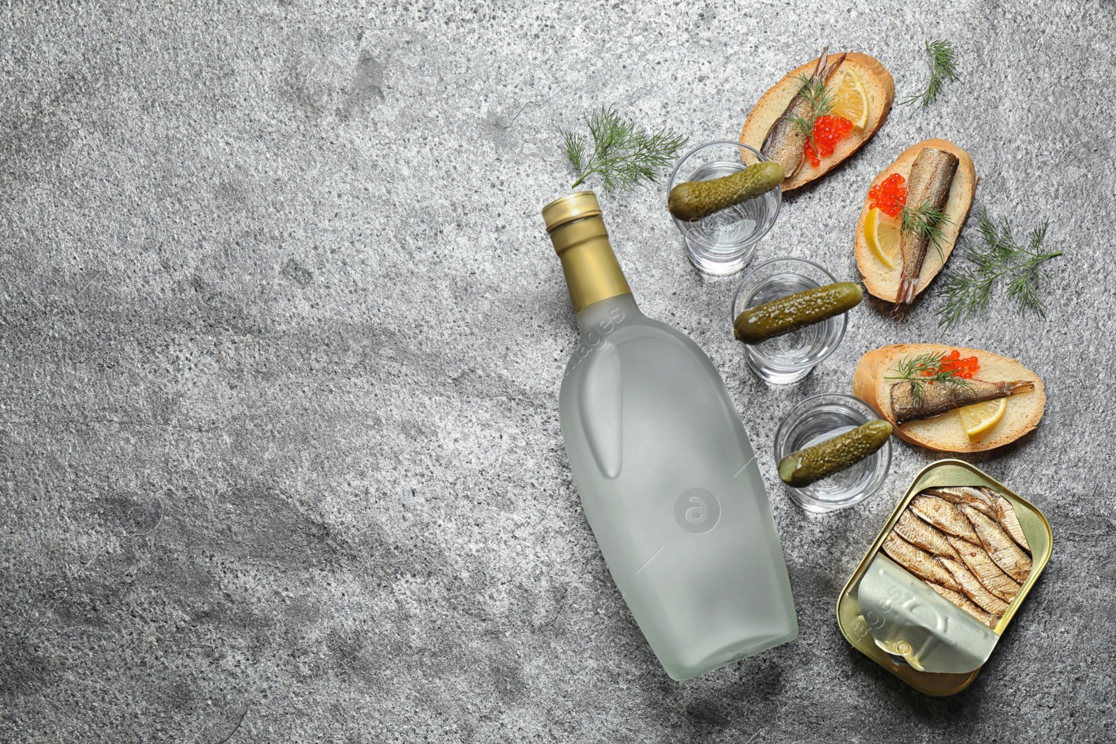 Photo of Flat lay composition with cold Russian vodka on grey table. Space for text