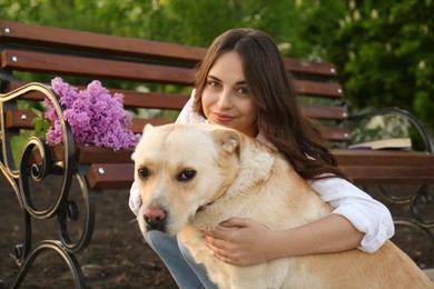 Woman with her pet near bench in park