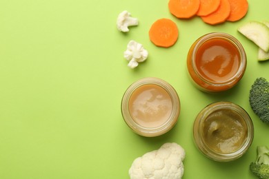 Photo of Jars with healthy baby food and fresh vegetables on light green background, flat lay. Space for text