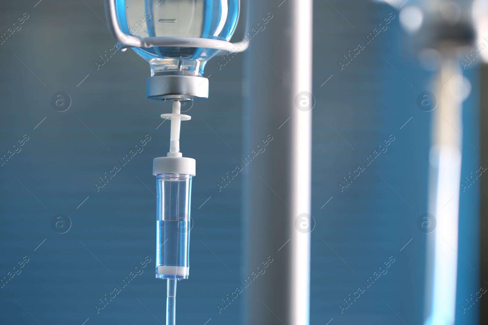 Photo of IV drip against blurred background, space for text