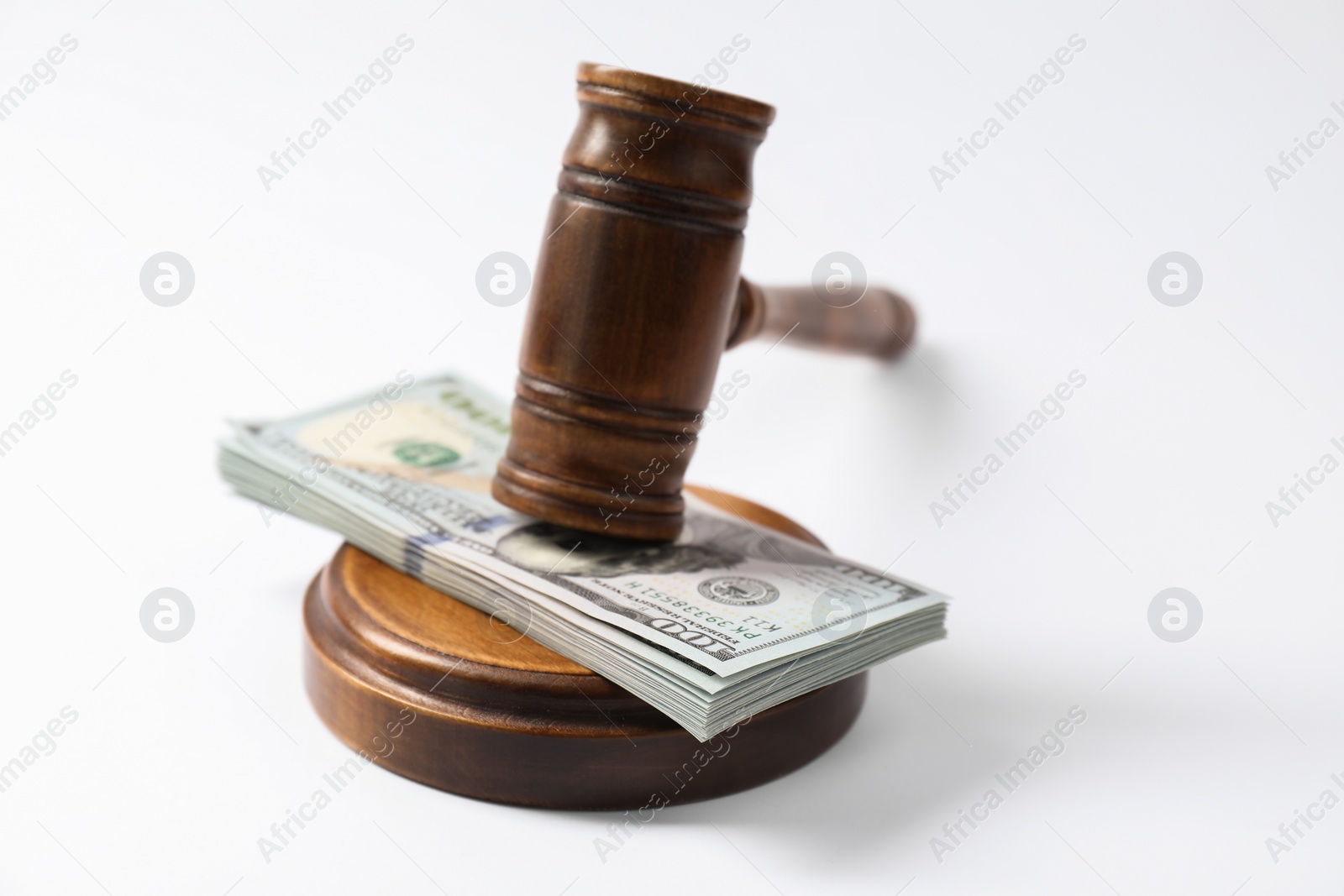 Photo of Law gavel with stack of dollars on white background