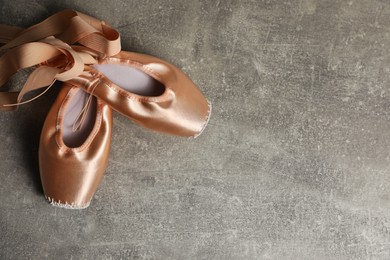 Photo of Ballet shoes. Elegant pointes on grey textured background, flat lay with space for text