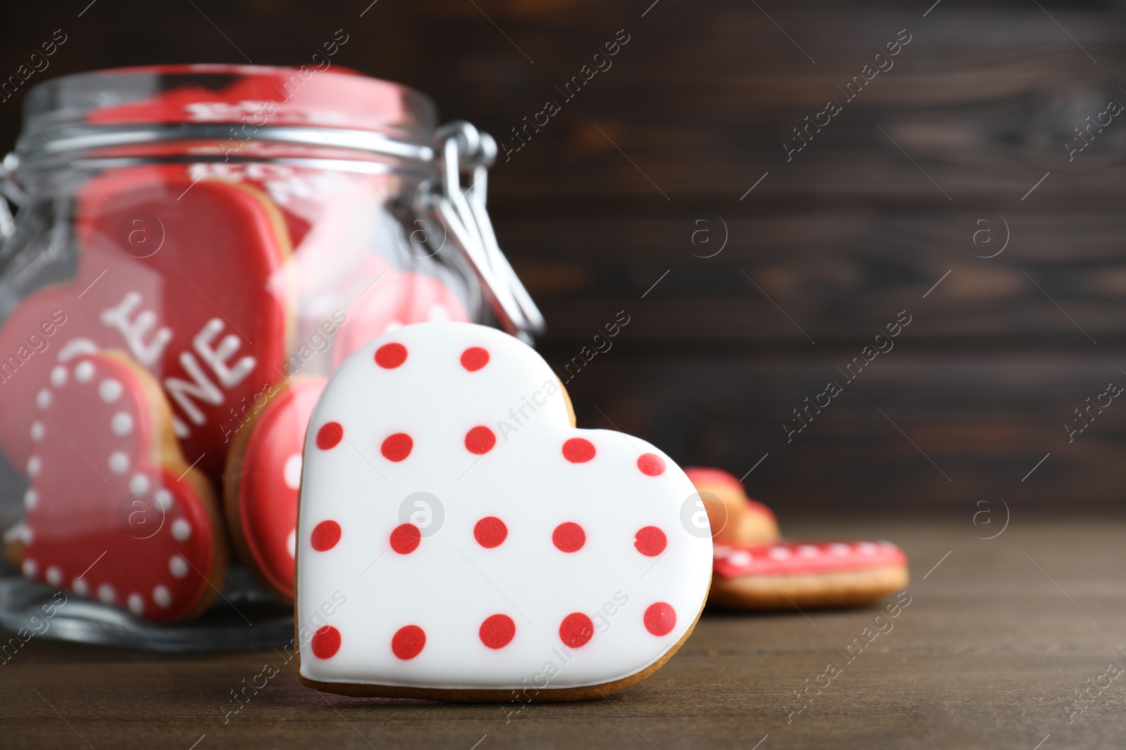 Photo of Delicious heart shaped cookies on wooden table, closeup with space for text. Valentine's Day