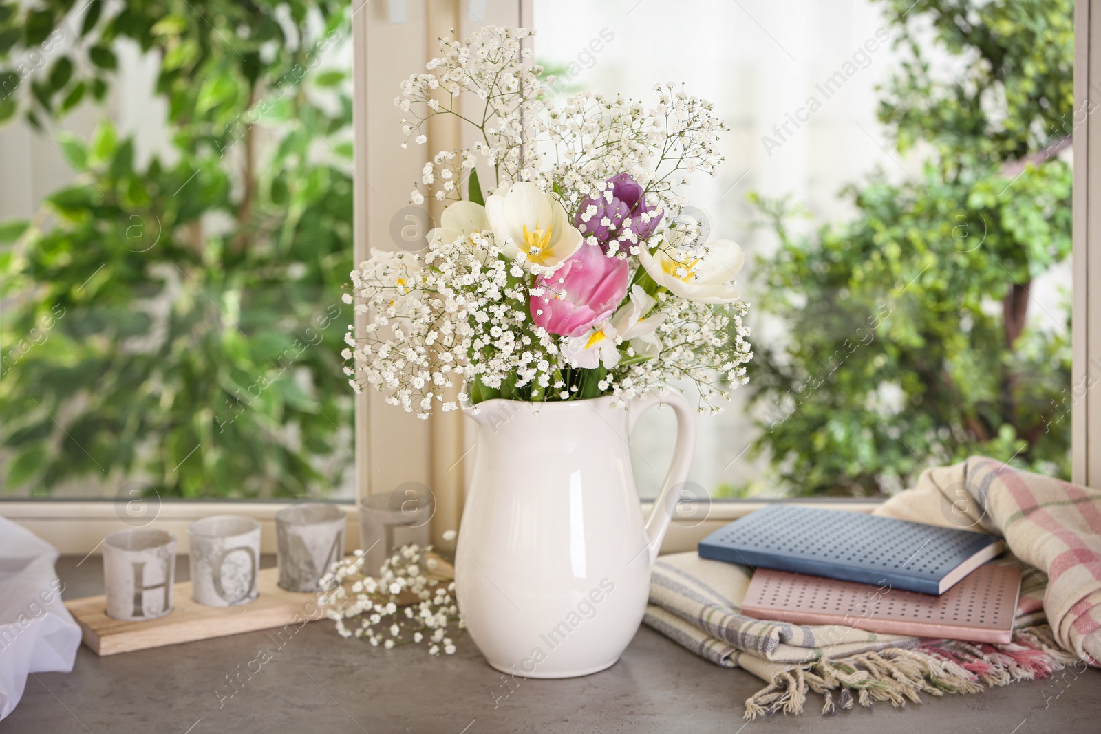 Photo of Beautiful fresh flowers on window sill indoors