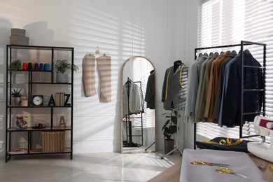 Tailor shop interior with mannequin and male suits on rack