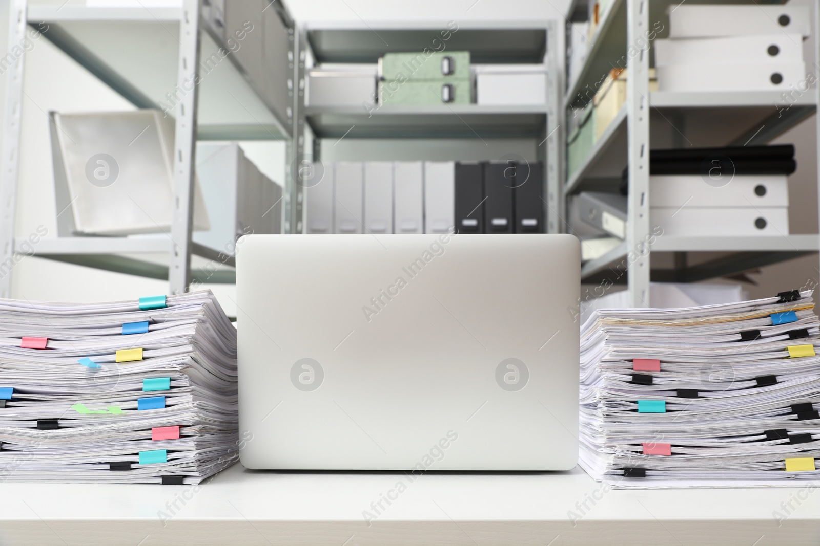 Photo of Laptop and documents on desk in office