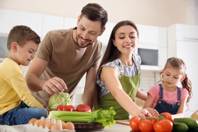 Happy family with children together in kitchen