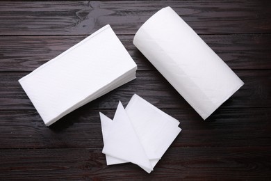 Photo of Clean tissues and paper towels on wooden table, flat lay