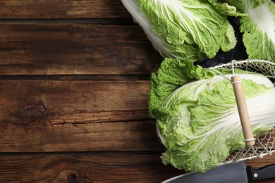 Photo of Ripe Chinese cabbages on wooden table, flat lay. Space for text