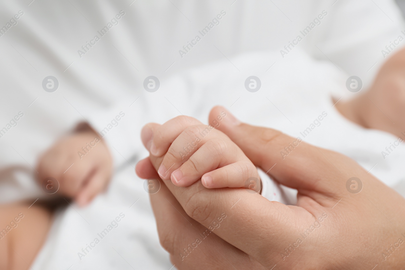 Photo of Father holding his cute baby, closeup view