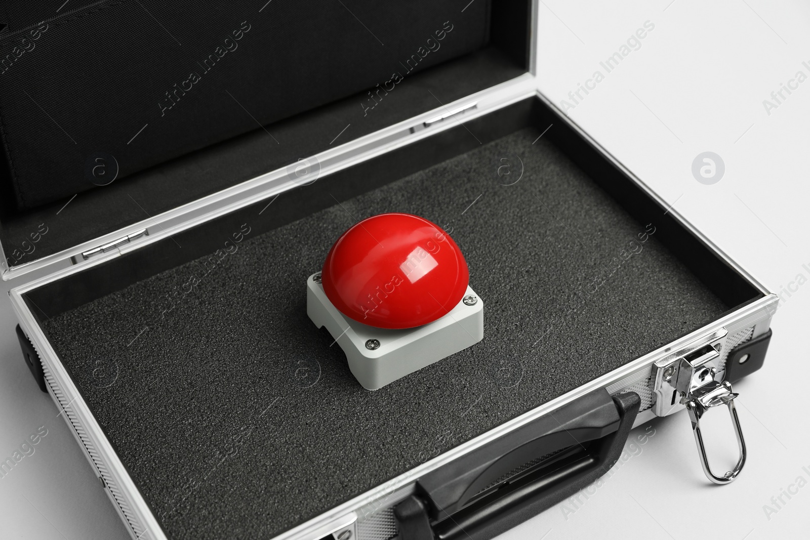 Photo of Red button of nuclear weapon in suitcase on white background. War concept