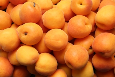 Delicious ripe sweet apricots as background, closeup view