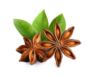 Aromatic dry anise stars and green leaves on white background