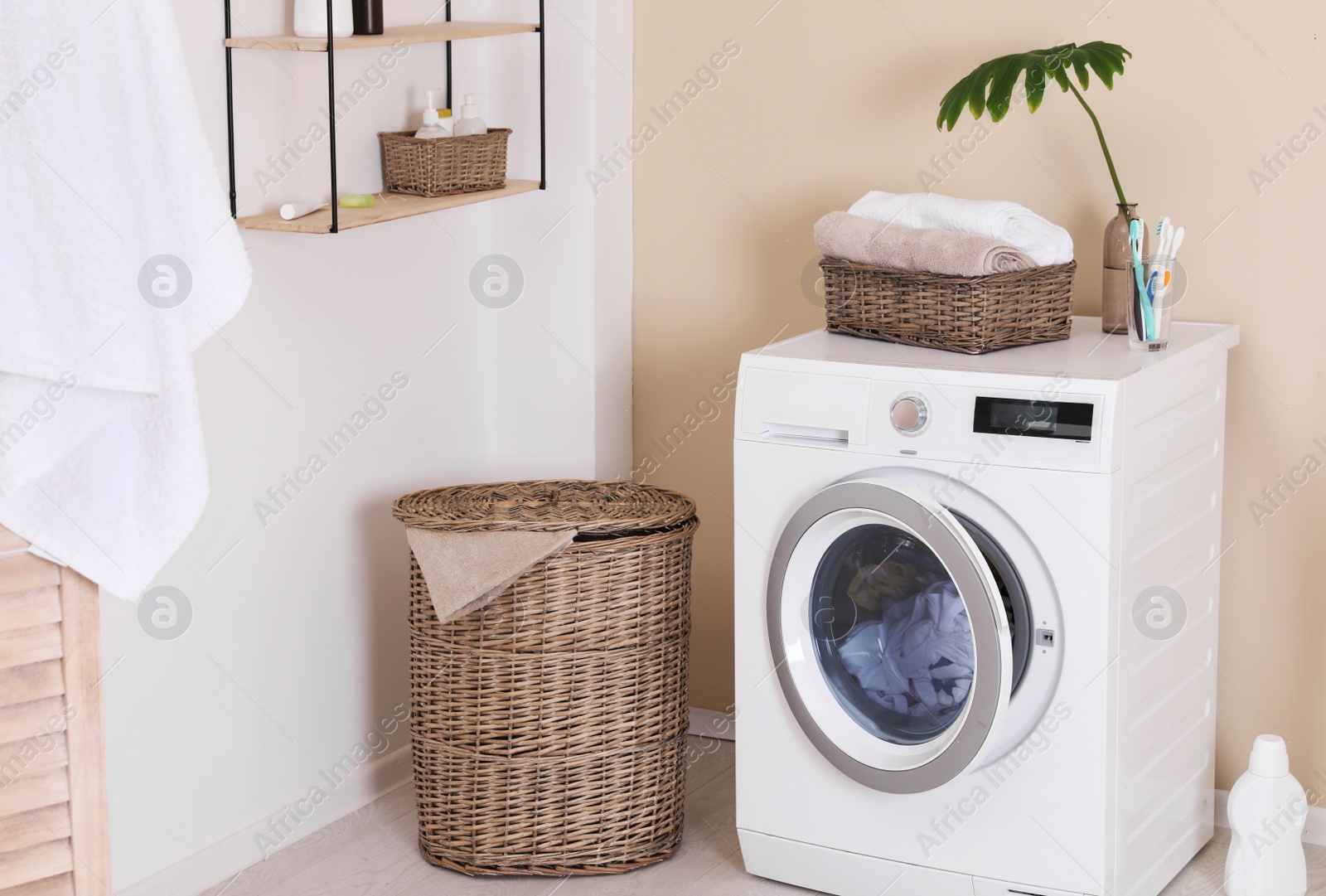 Photo of Laundry room interior with washing machine near wall