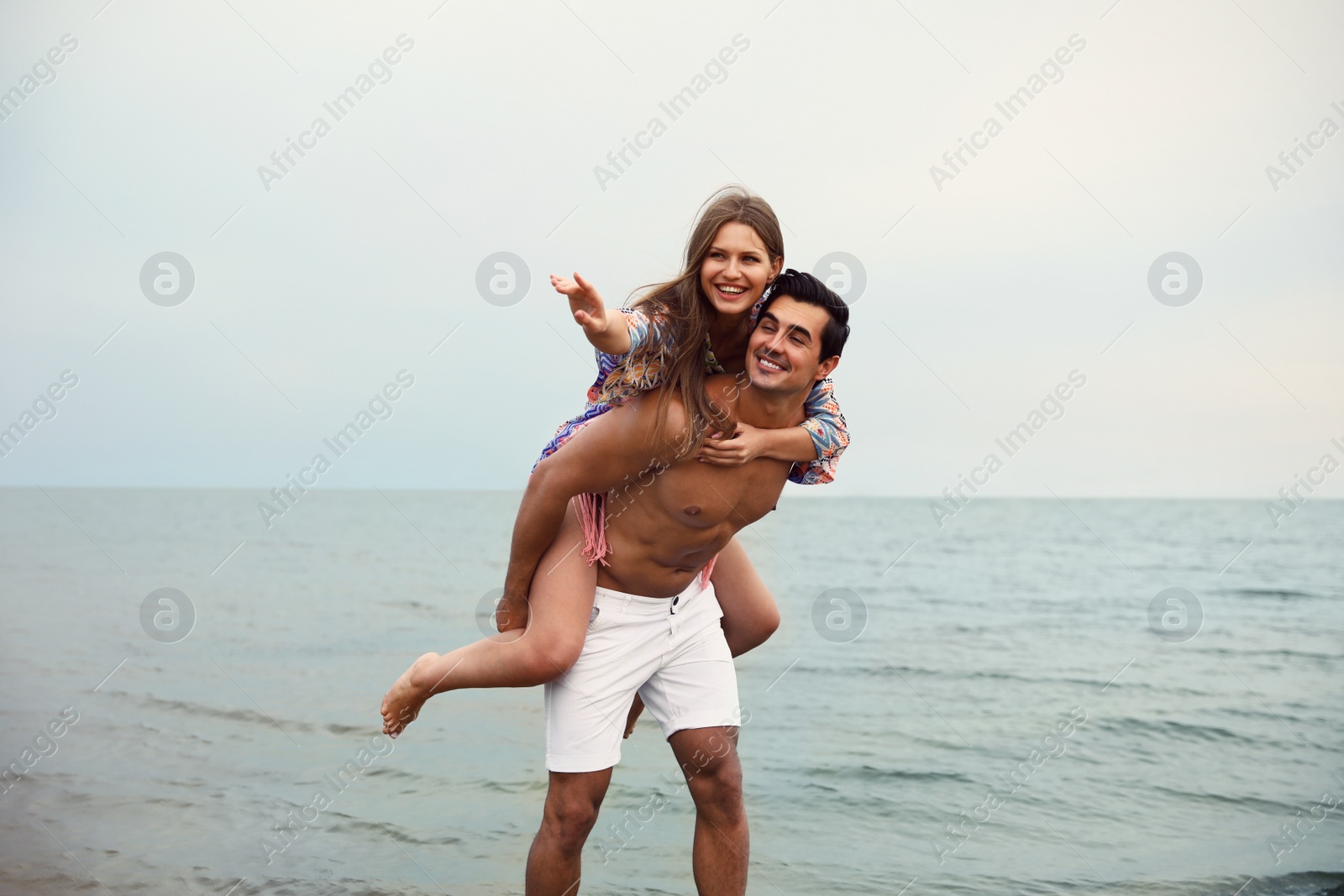 Photo of Happy young couple having fun on sea beach