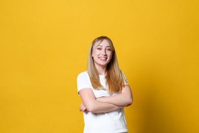 Beautiful young woman laughing on yellow background. Funny joke