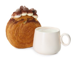 Round croissant with chocolate chips and cup of drink isolated on white. Tasty puff pastry