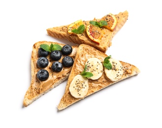 Photo of Different toasts with fruits, blueberries, peanut butter and chia seeds on white background