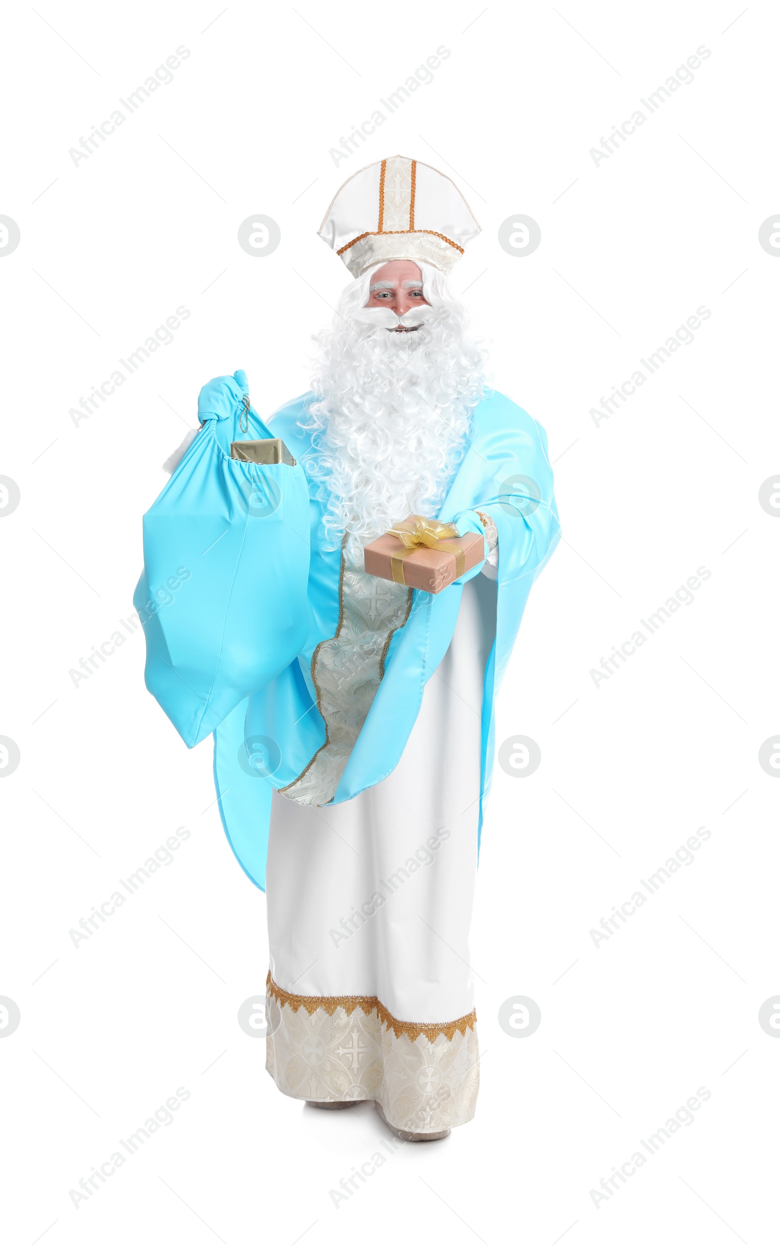 Photo of Full length portrait of Saint Nicholas holding sack with presents on white background