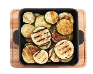 Photo of Grill pan with delicious zucchini slices on white background, top view