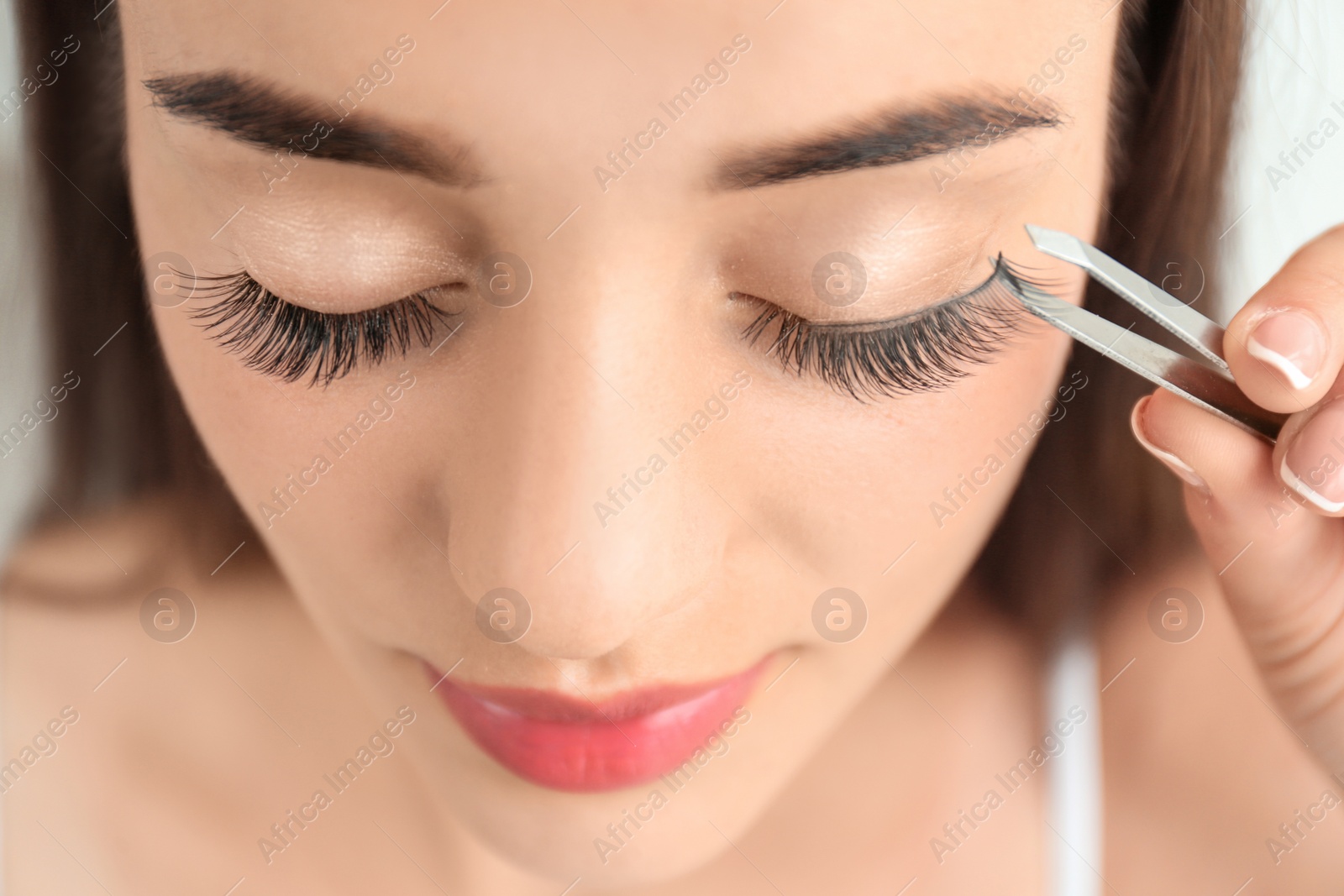 Photo of Attractive young woman with false eyelashes, closeup