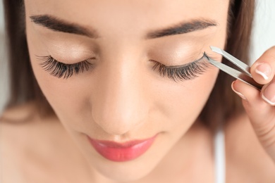 Attractive young woman with false eyelashes, closeup