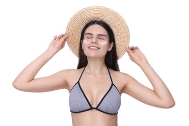 Beautiful young woman with sun protection cream on her face against white background