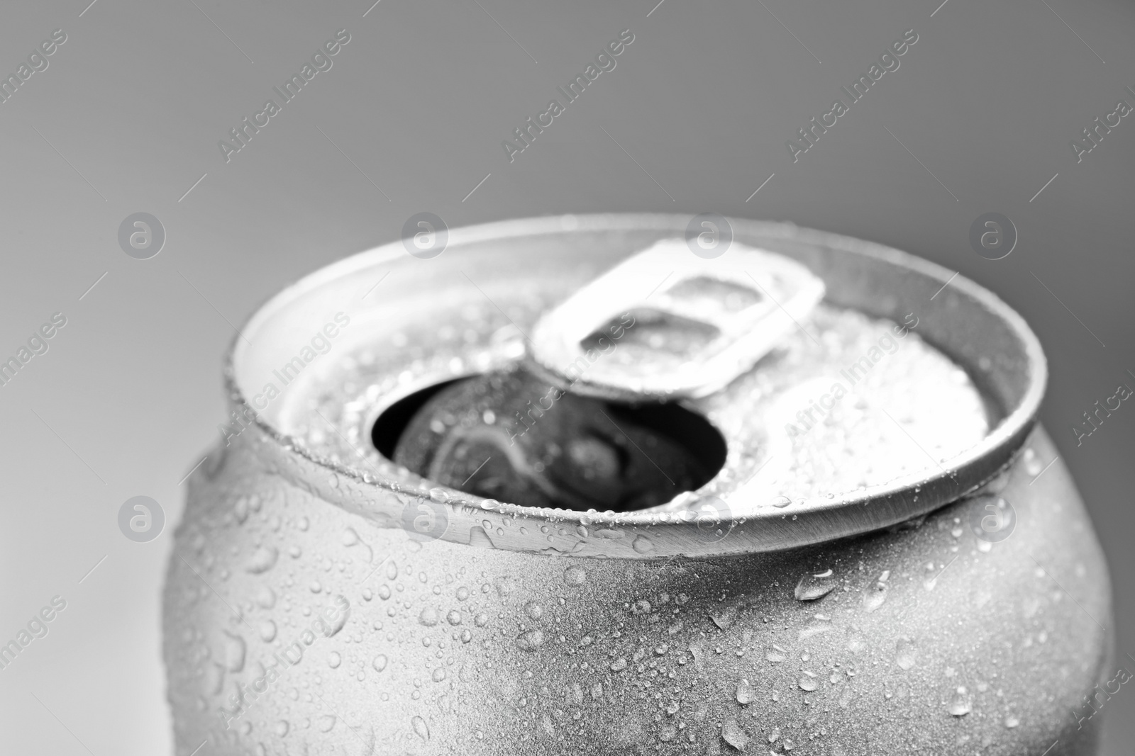 Photo of Wet open can on grey background, closeup