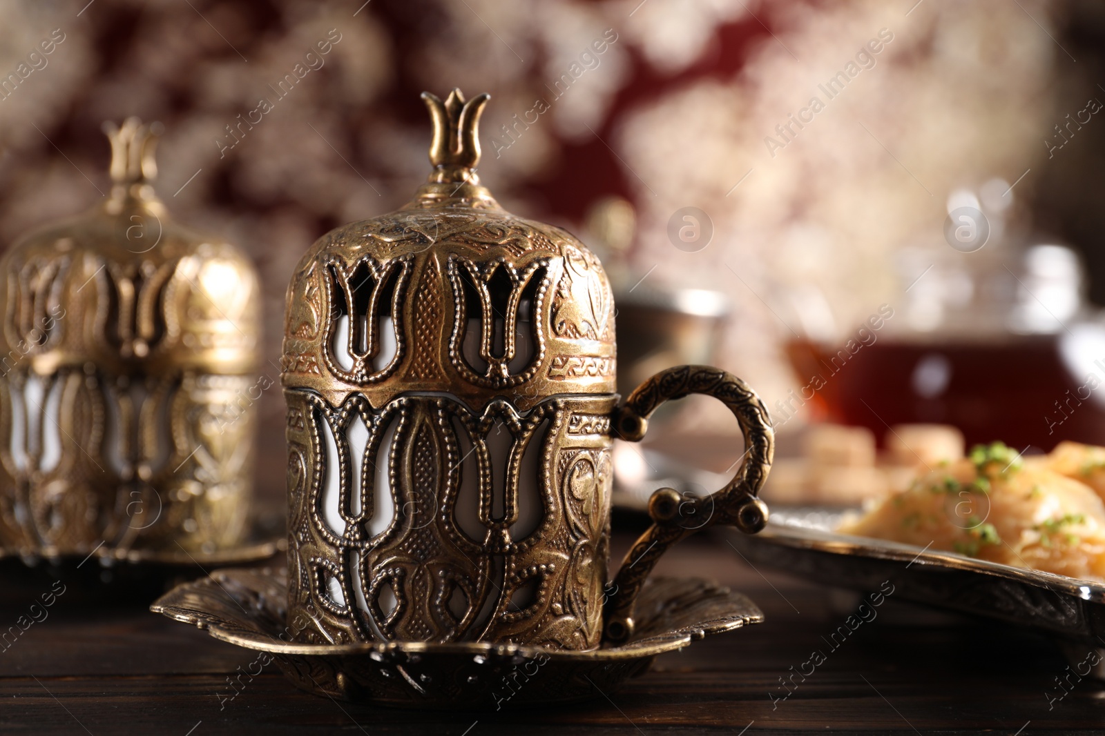 Photo of Traditional Turkish tea served in vintage tea set on wooden table