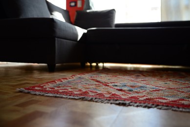 Photo of Living room with beautiful carpet and sofa, low angle view