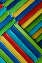 Photo of Many bright counting sticks as background, top view