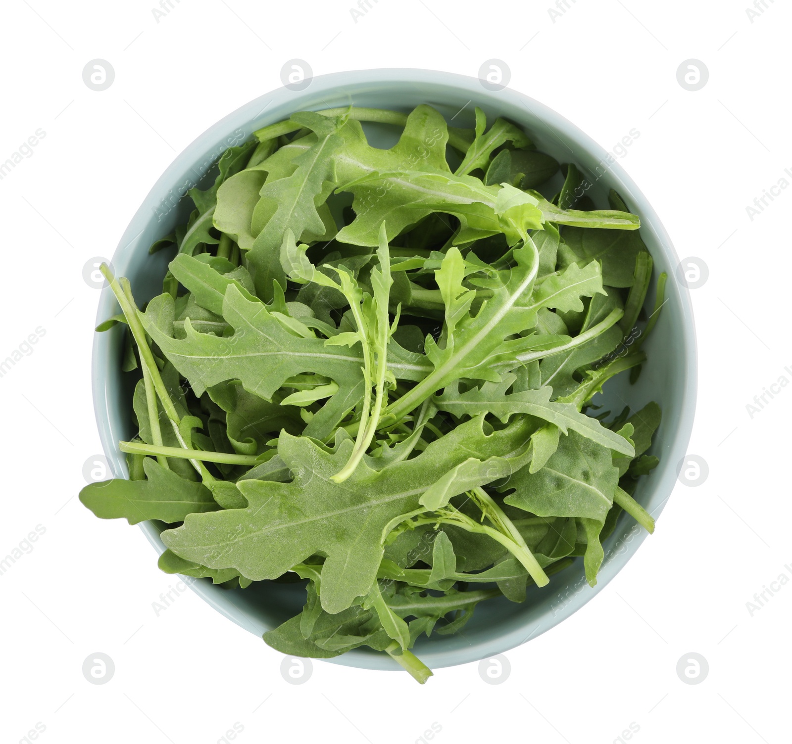 Photo of Delicious fresh arugula in bowl isolated on white, top view