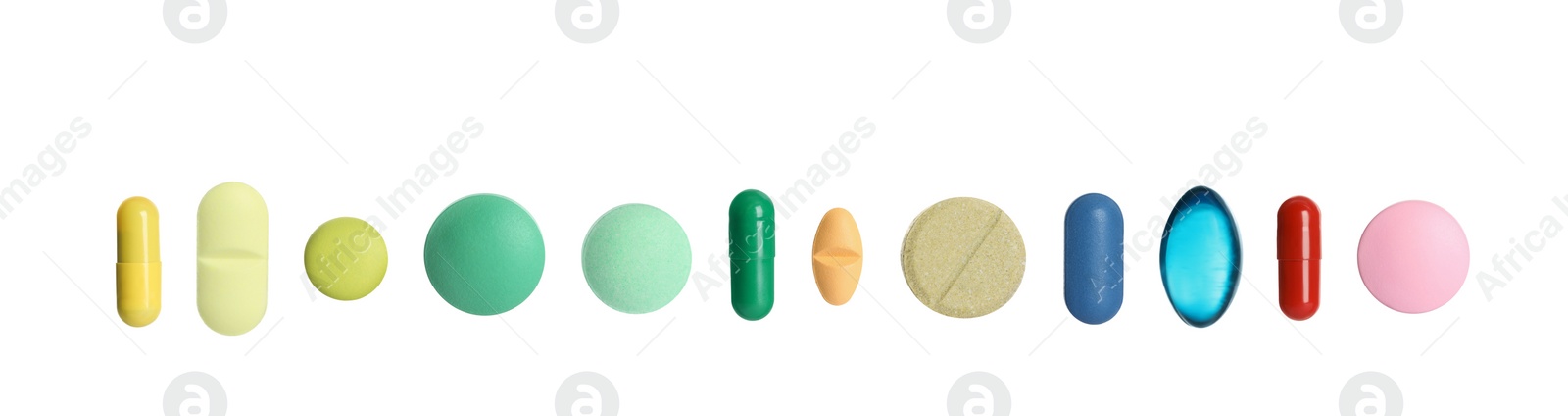 Image of Set of different color pills in row isolated on white