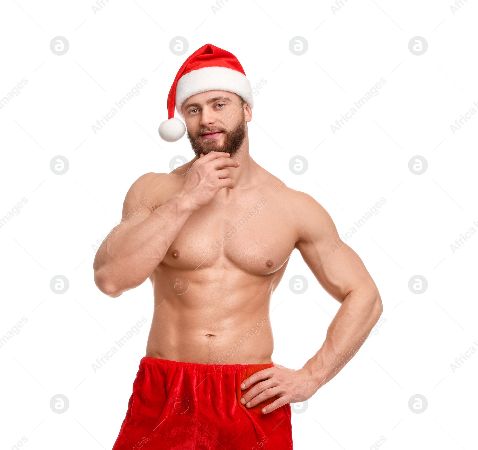 Photo of Attractive young man with muscular body in Santa hat on white background