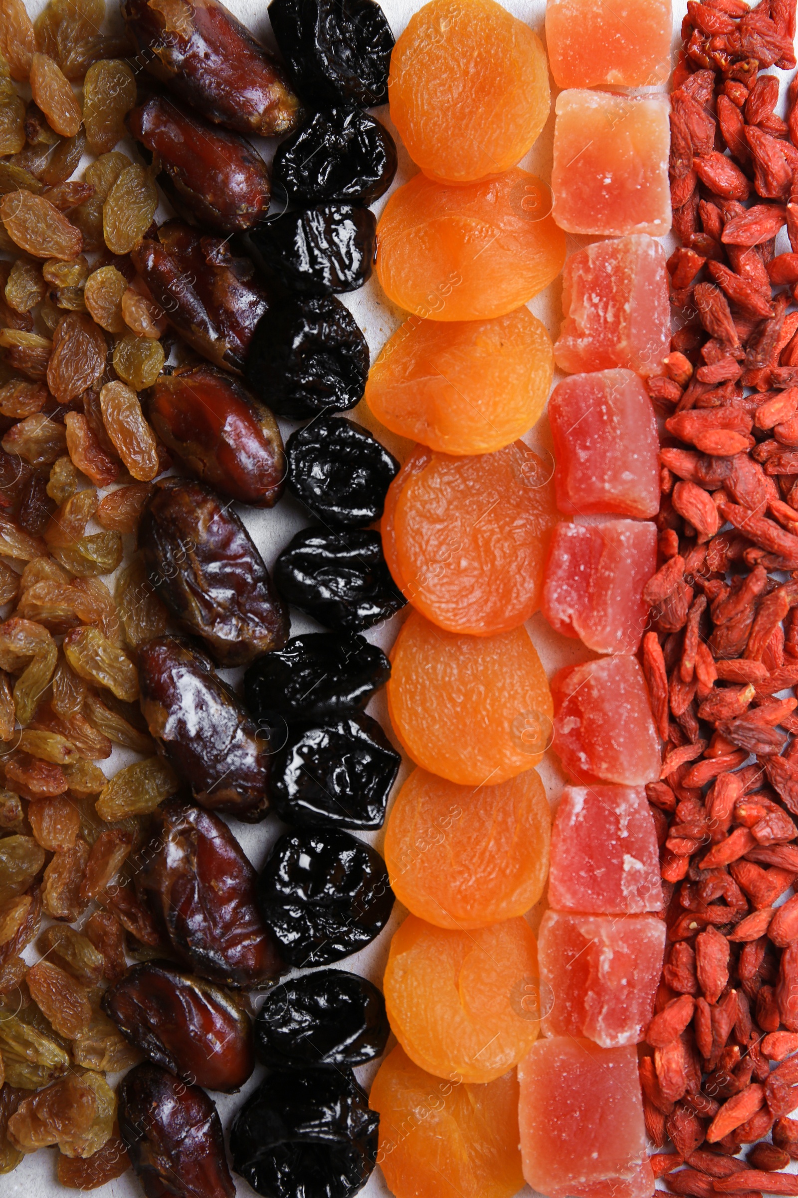 Photo of Different tasty dried fruits as background, top view