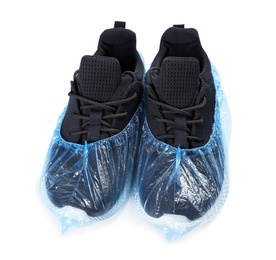 Pair of sneakers in medical blue covers on white background