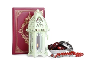Decorative Arabic lantern, Quran, misbaha and dates on white background