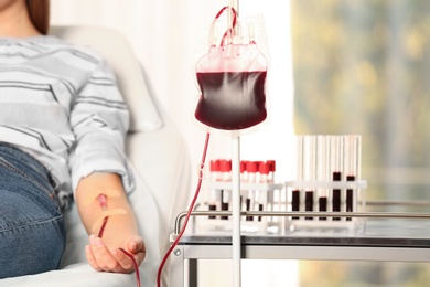 Photo of Woman making blood donation at hospital, closeup