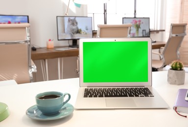 Image of Laptop display with chroma key on desk in room. Comfortable workplace with modern computer