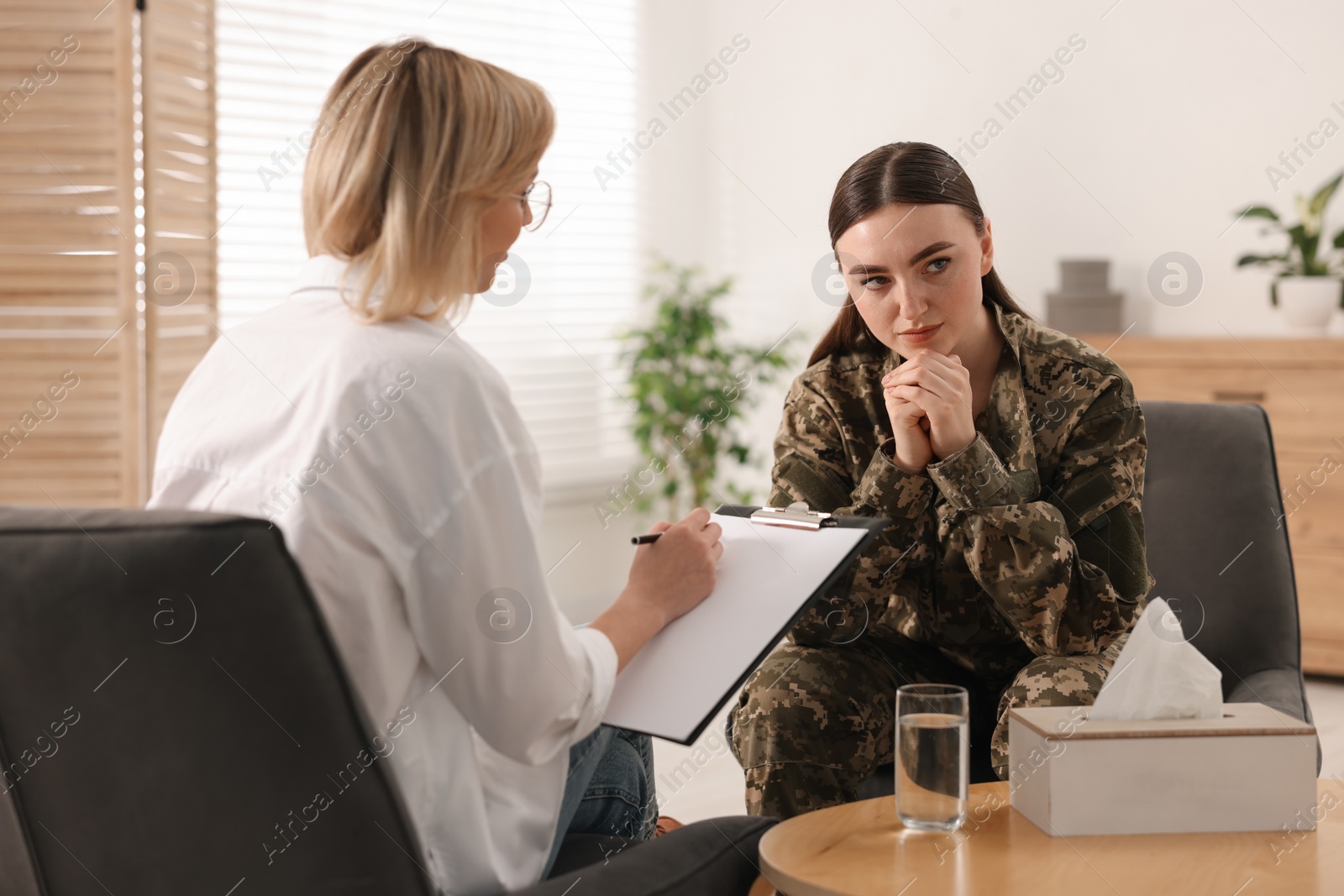 Photo of Psychotherapist working with military woman in office