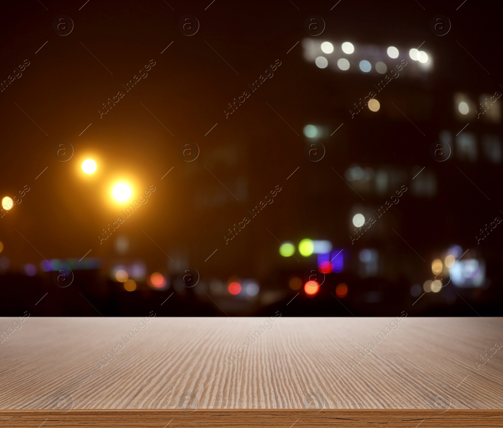 Image of Empty wooden surface and blurred view of night city. Bokeh effect 