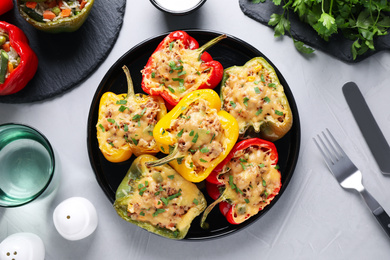 Photo of Tasty stuffed bell peppers served on light grey table, flat lay