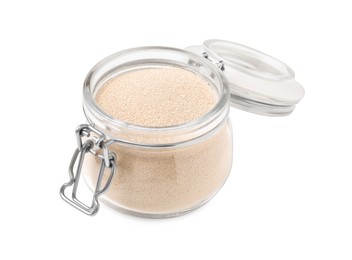 Photo of Granulated yeast in glass jar isolated on white
