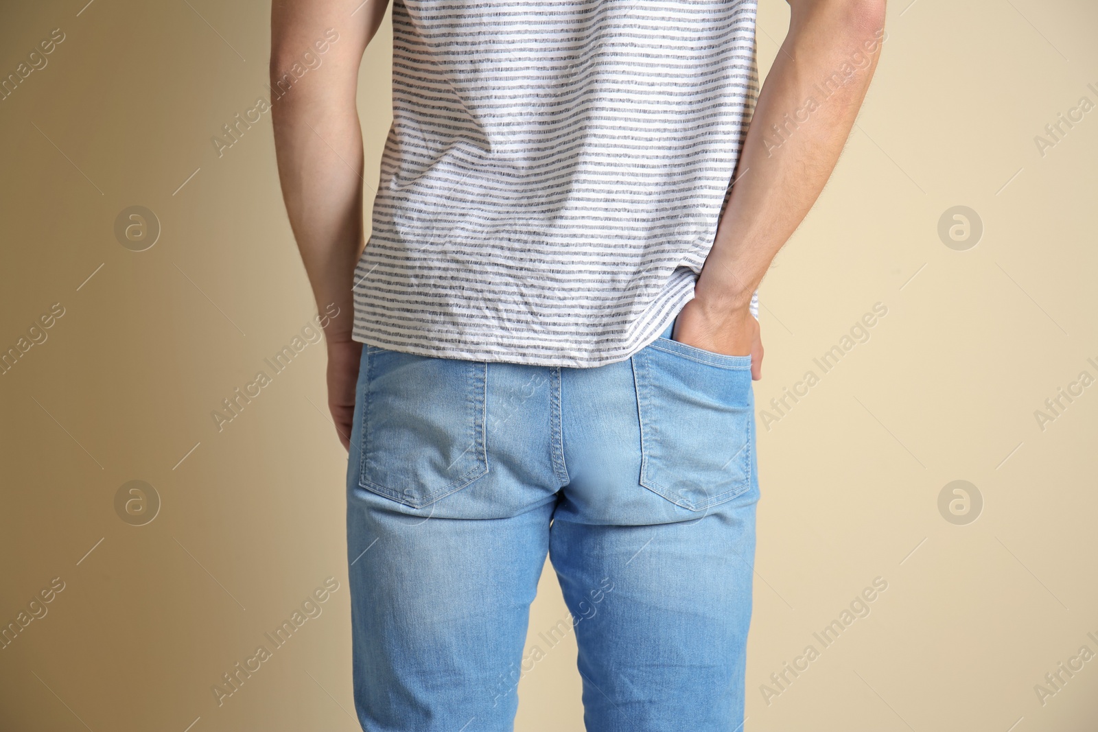 Photo of Young man in stylish jeans on light background