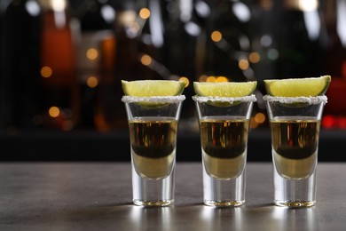 Mexican Tequila shots, lime slices and salt on bar counter