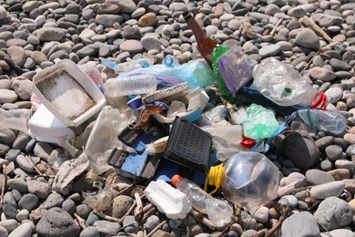 Photo of Pile of garbage on stones outdoors. Environmental Pollution concept
