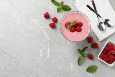 Photo of Delicious raspberry mousse with mint on grey marble table, flat lay. Space for text